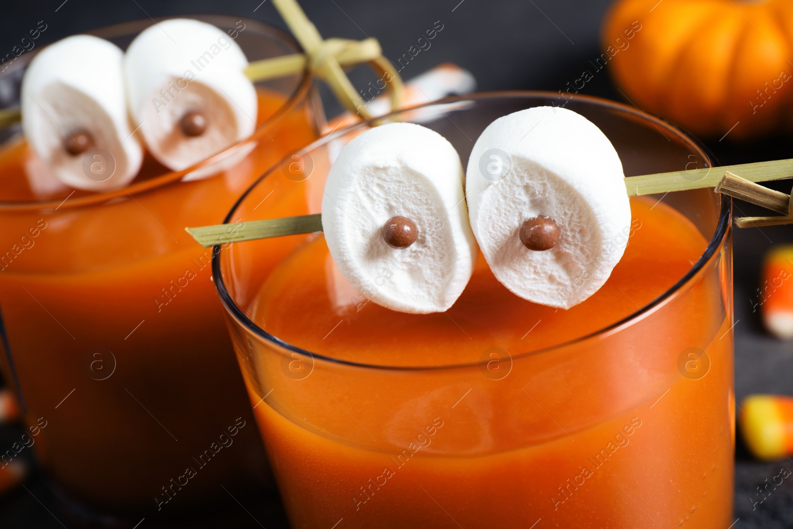 Photo of Decorated glasses with drinks, closeup. Halloween celebration