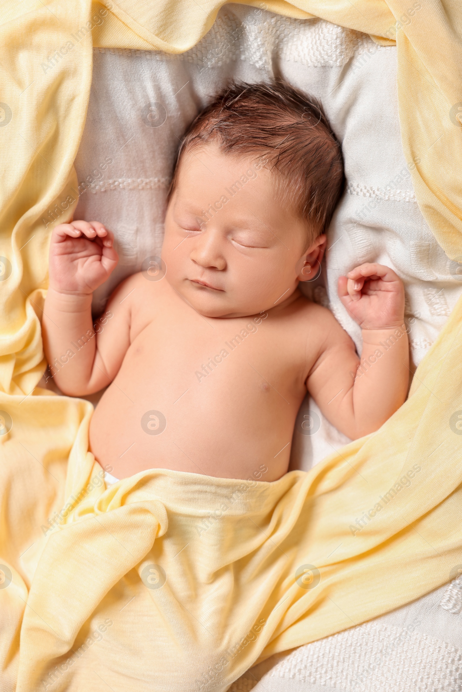 Photo of Cute newborn baby sleeping on white blanket, top view