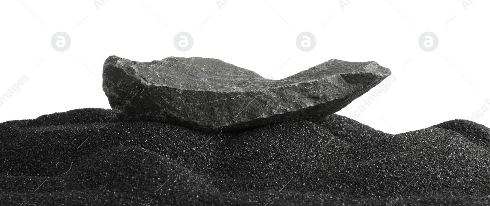 Photo of Presentation of product. Stone podium on black sand against white background