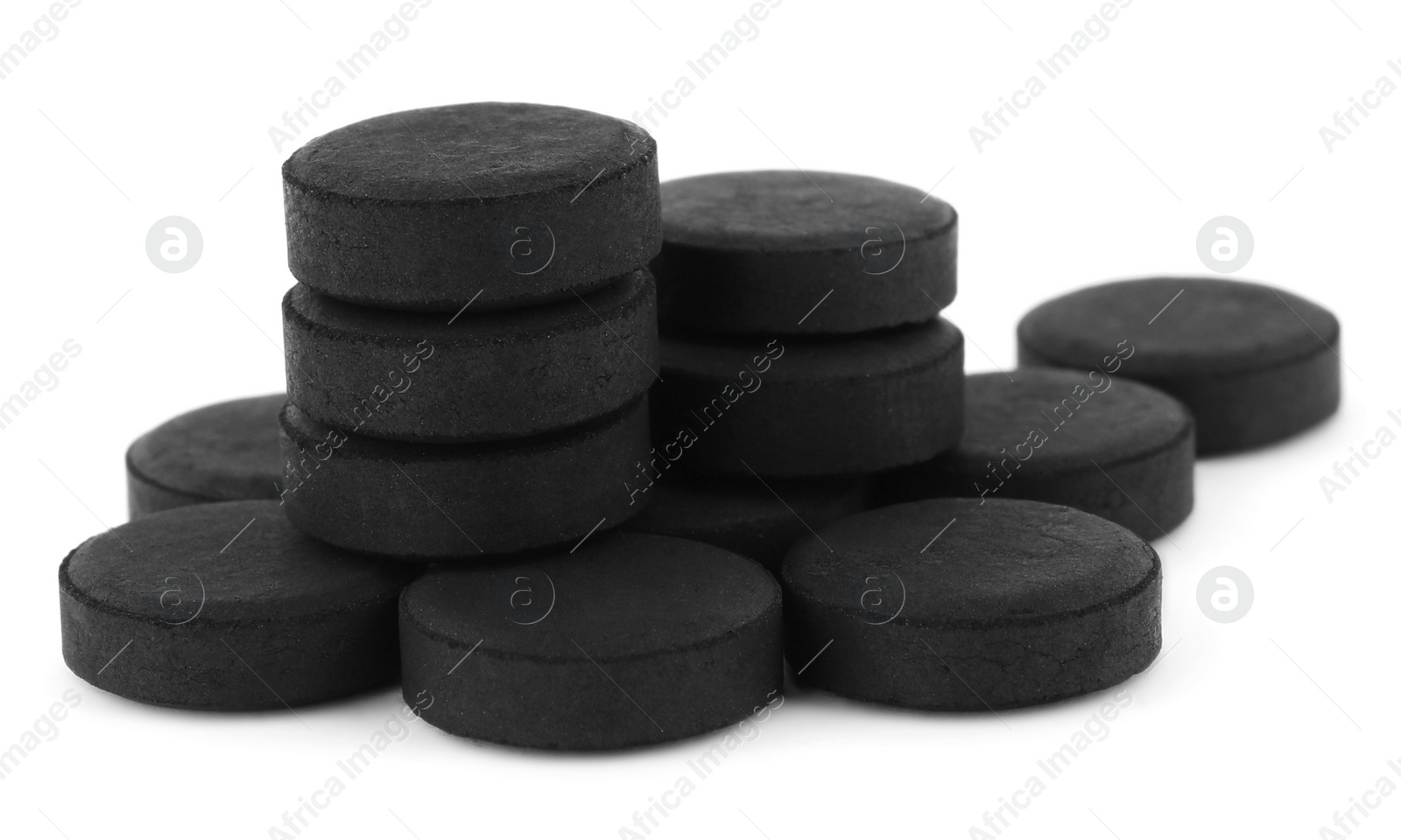 Photo of Activated charcoal pills on white background. Potent sorbent