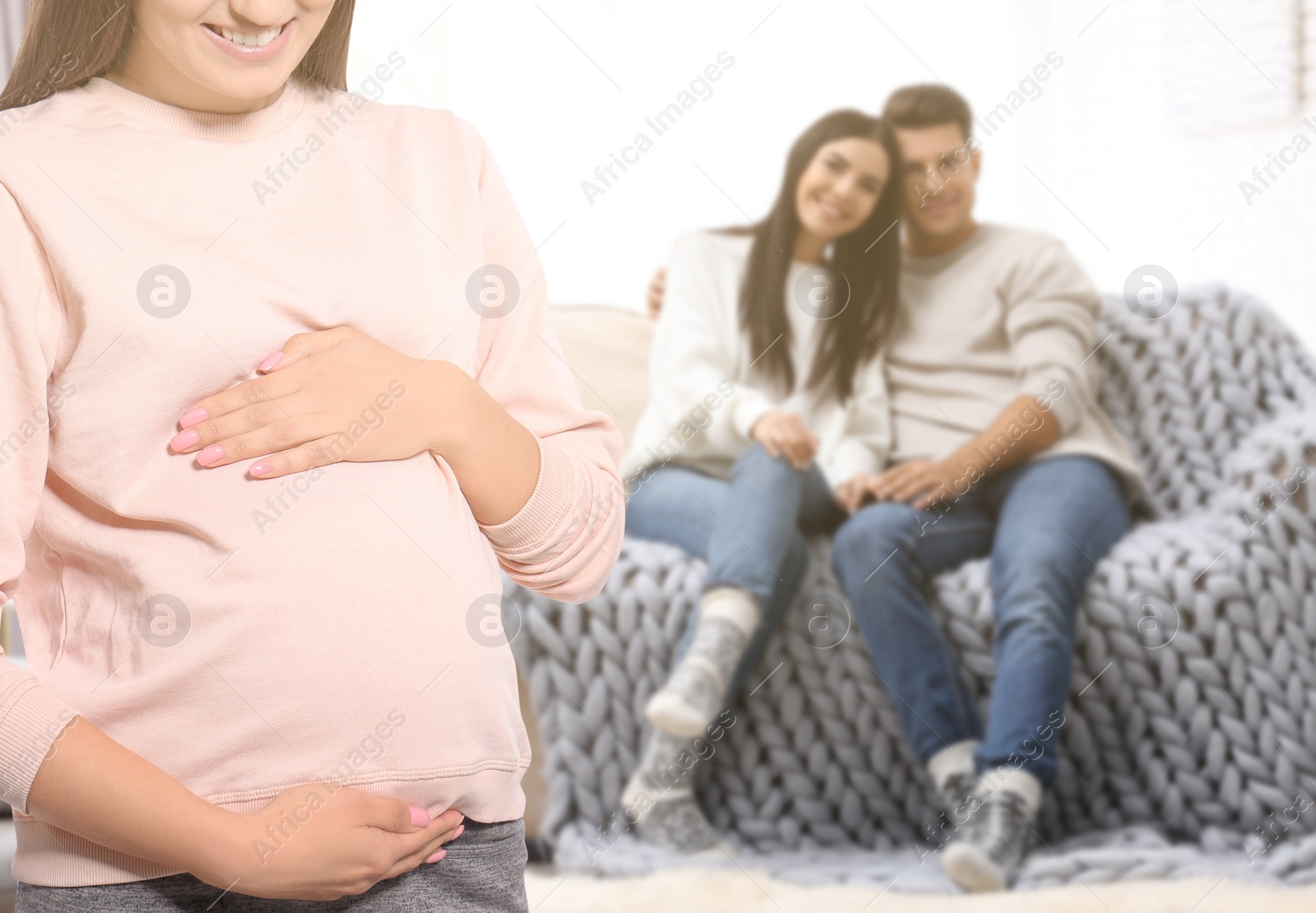 Image of Surrogate mother and intended parents in room