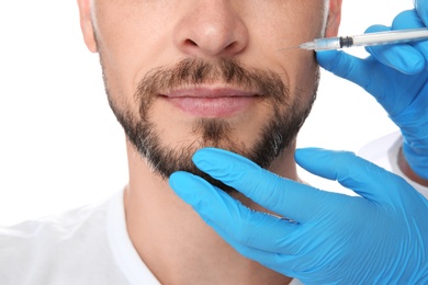 Photo of Mature man getting facial injection on white background, closeup. Cosmetic surgery concept