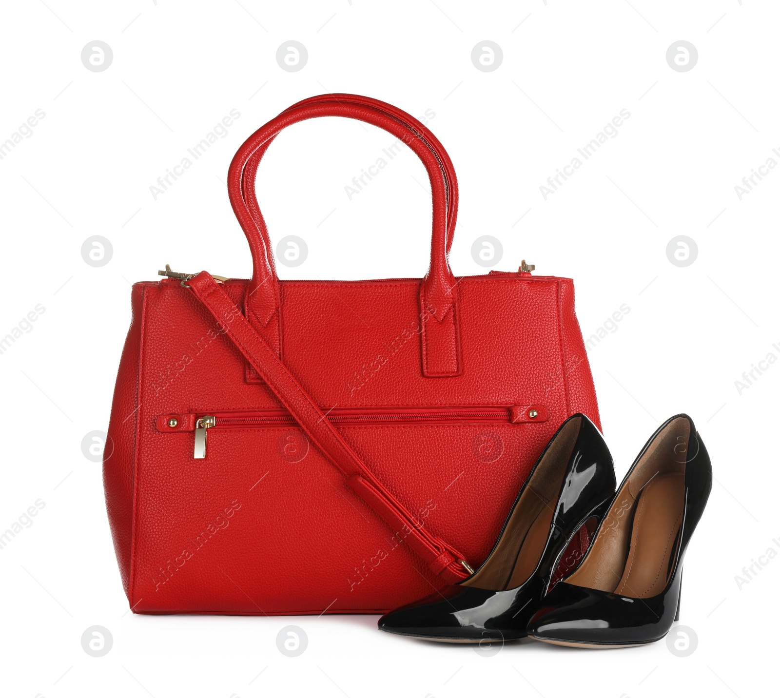 Photo of Red women's bag and high heeled shoes on white background