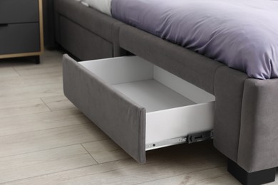 Photo of Storage drawer for bedding under modern bed in room