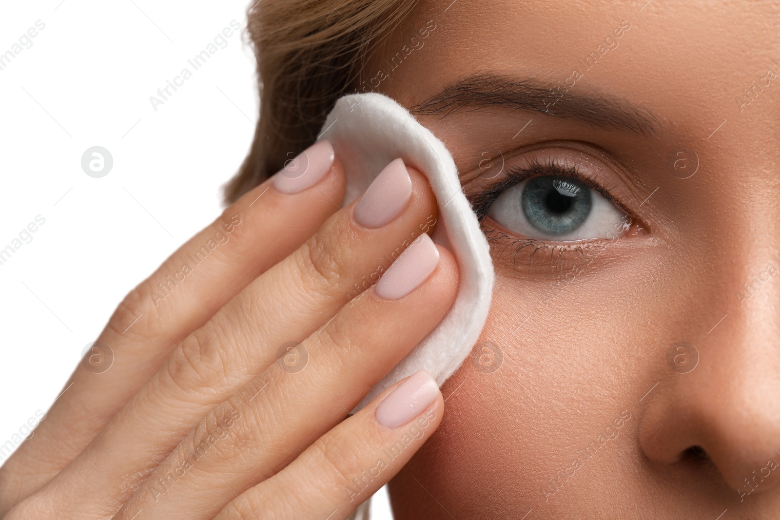 Photo of Woman removing makeup with cotton pad on white background, closeup