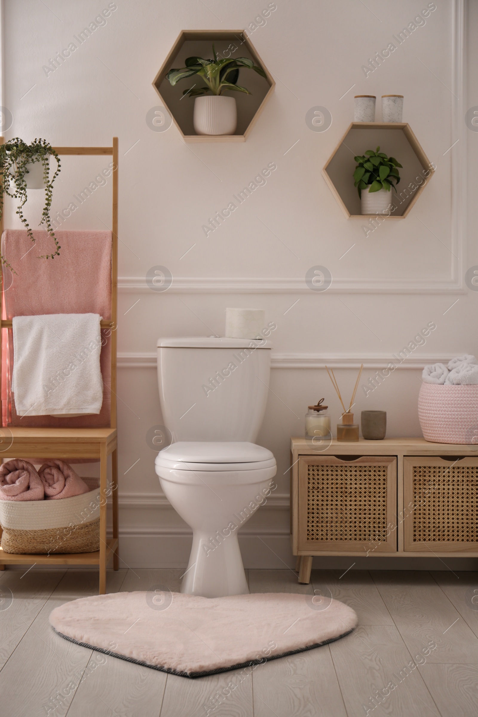 Photo of Stylish bathroom interior with toilet bowl and other essentials