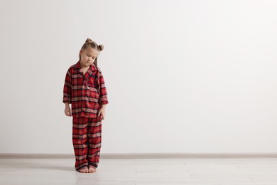 Photo of Girl in pajamas sleepwalking indoors, space for text