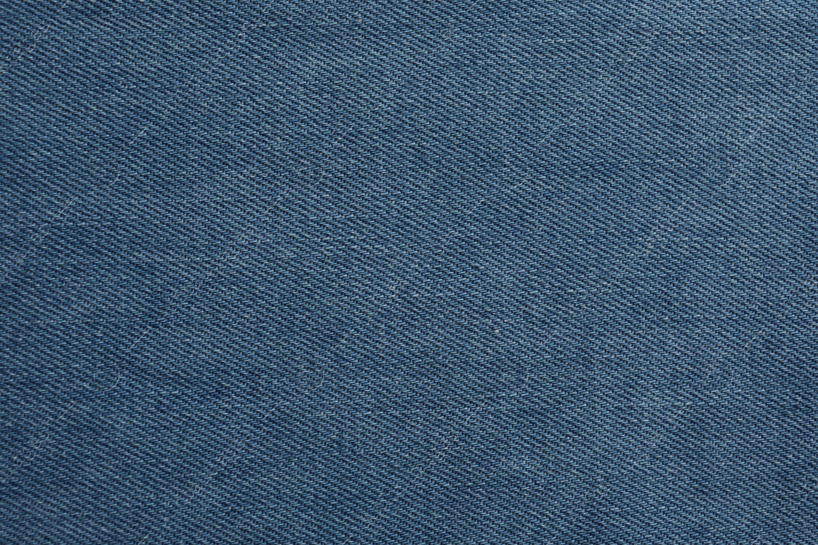 Photo of Texture of blue jeans as background, closeup