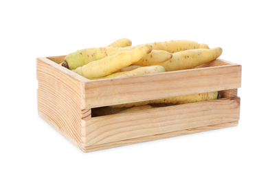 Photo of Fresh raw carrots in wooden crate isolated on white