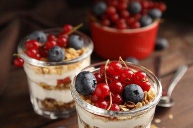 Photo of Delicious yogurt parfait with fresh berries on table, closeup