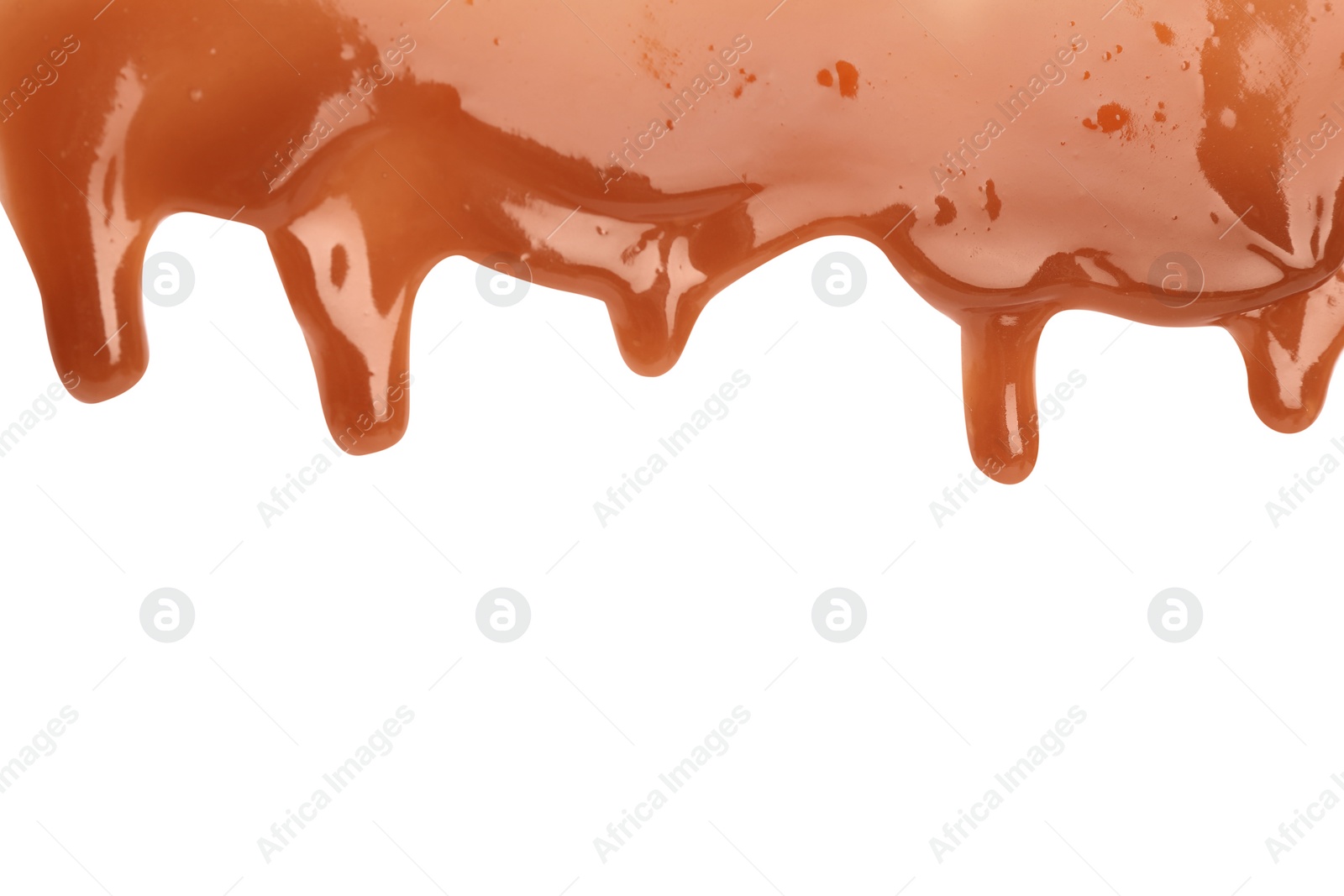 Photo of Delicious caramel sauce flowing on white background