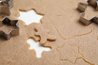 Homemade Christmas biscuits. Raw dough and cookie cutters on table, closeup