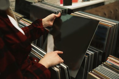 Woman choosing vinyl records in store, closeup