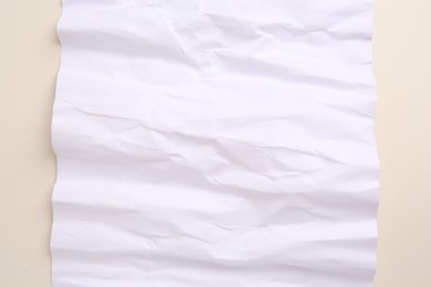 Photo of Sheet of crumpled parchment paper on beige background, top view