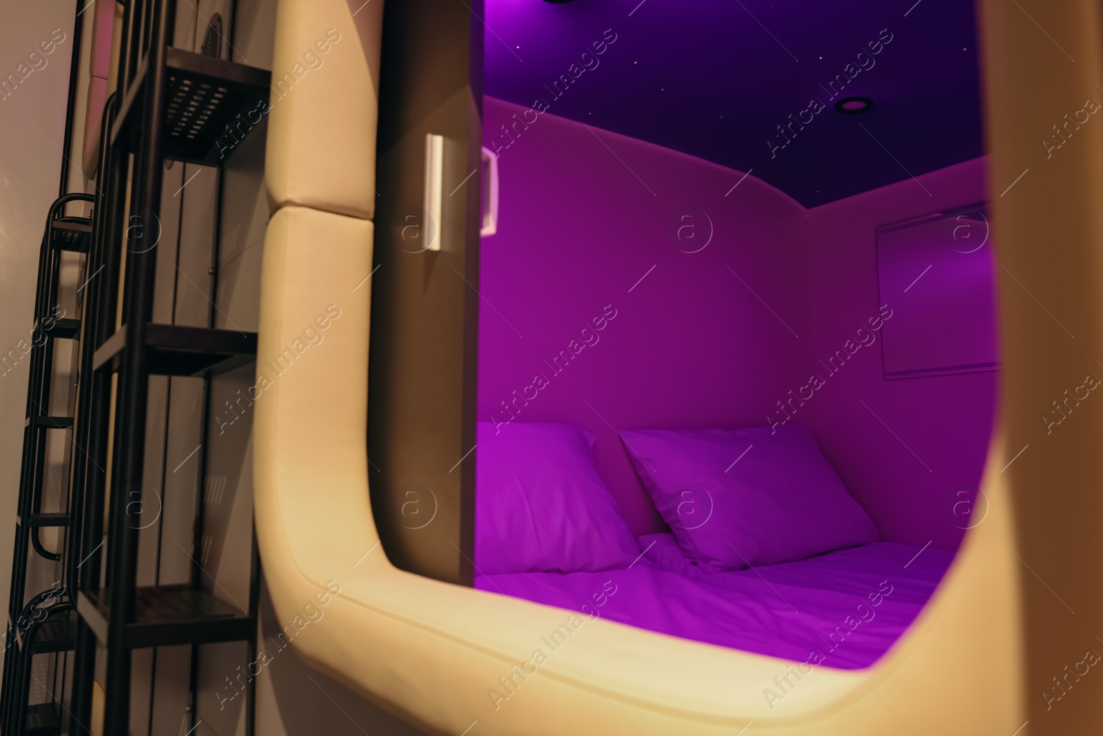 Photo of Capsule with twin bed in modern pod hostel. Stylish interior