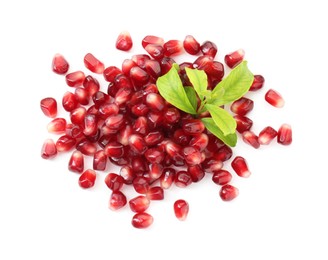 Photo of Pile of tasty pomegranate grains and leaves isolated on white, top view
