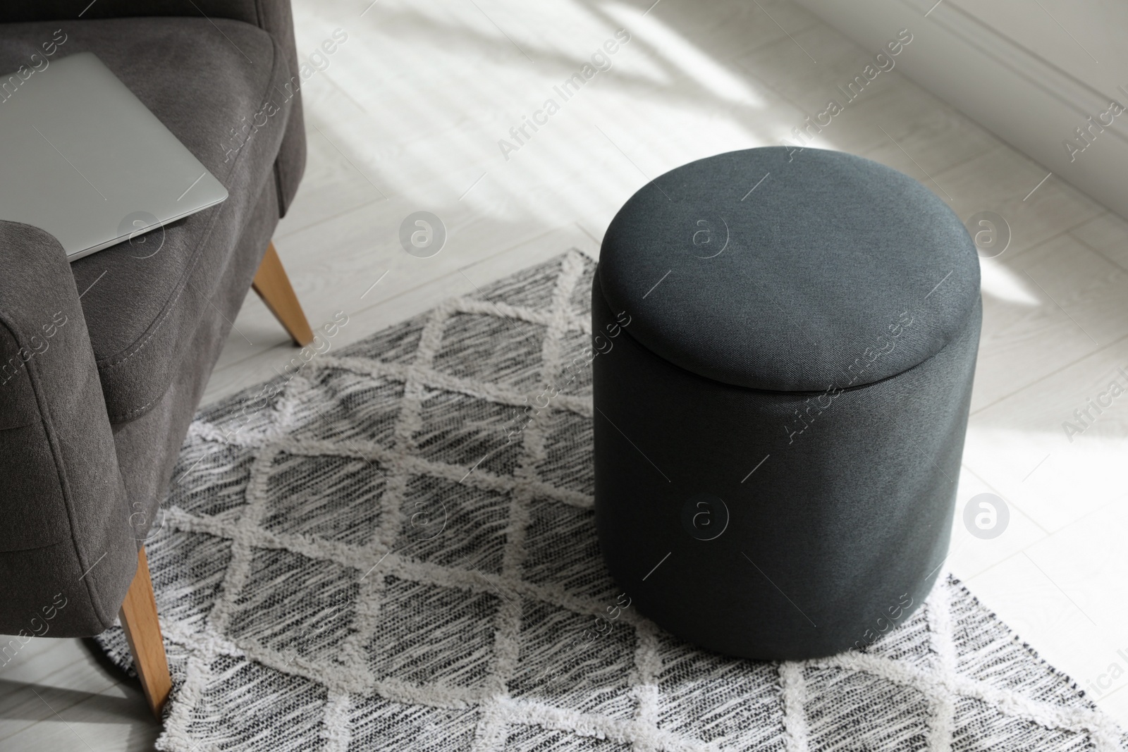 Photo of Stylish comfortable ottoman in room. Home design