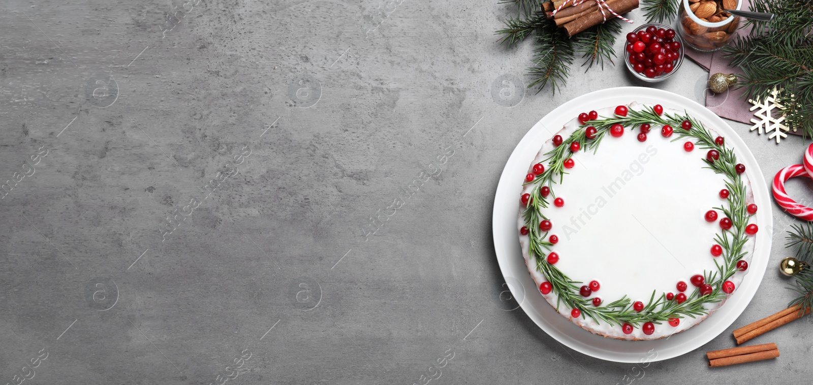 Image of Flat lay composition with traditional Christmas cake on light grey table, space for text. Banner design 