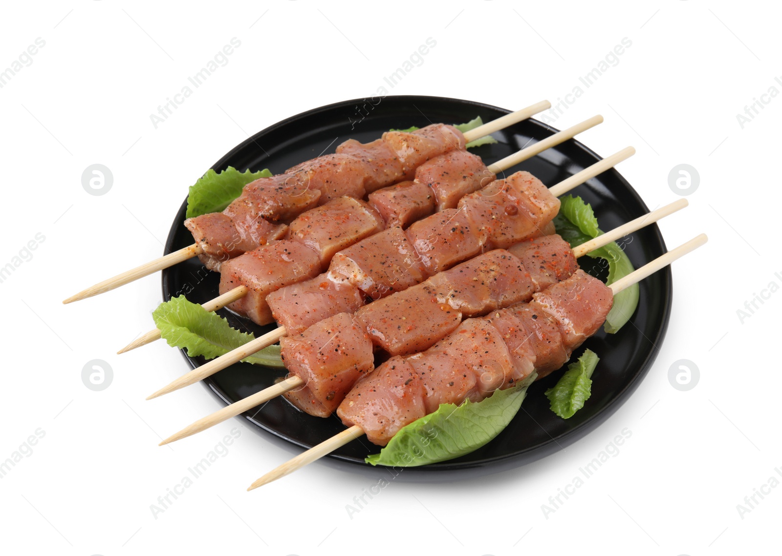 Photo of Wooden skewers with cut raw marinated meat isolated on white