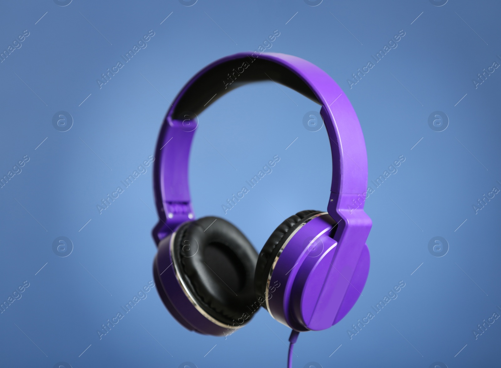 Photo of Stylish headphones with pads on color background