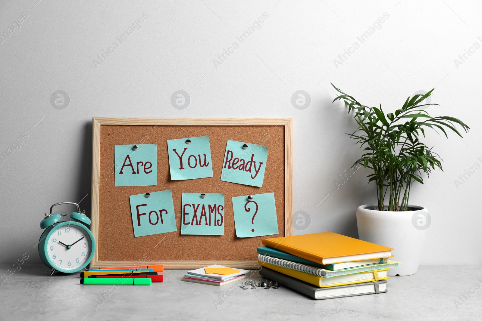 Photo of Cork board with question Are You Ready For Exams made of sticky notes on table