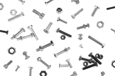 Image of Many different bolts and nuts falling on white background