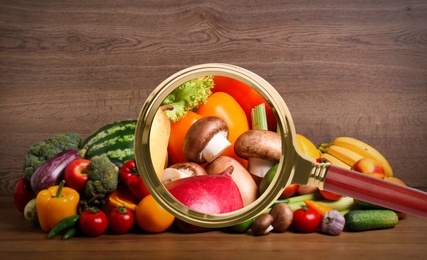 Image of Magnifying glass focusing on mushrooms. Food control 