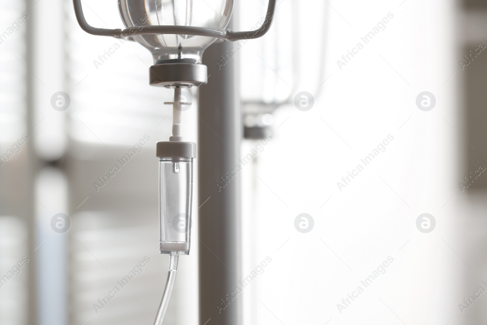 Photo of IV drip against blurred background, space for text