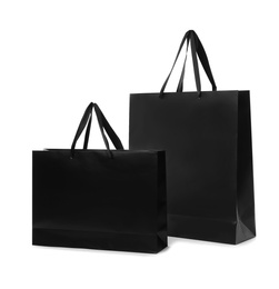 Photo of Paper shopping bags with handles on white background. Mockup for design