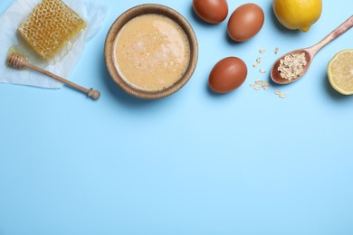 Photo of Homemade hair mask and ingredients on light blue background, flat lay. Space for text