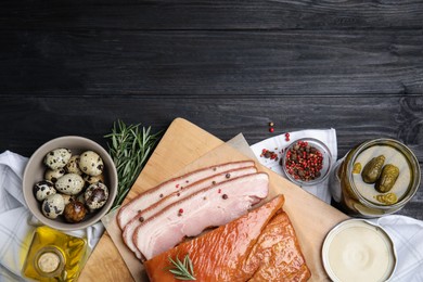 Photo of Flat lay composition with delicious smoked bacon on black wooden table, space for text