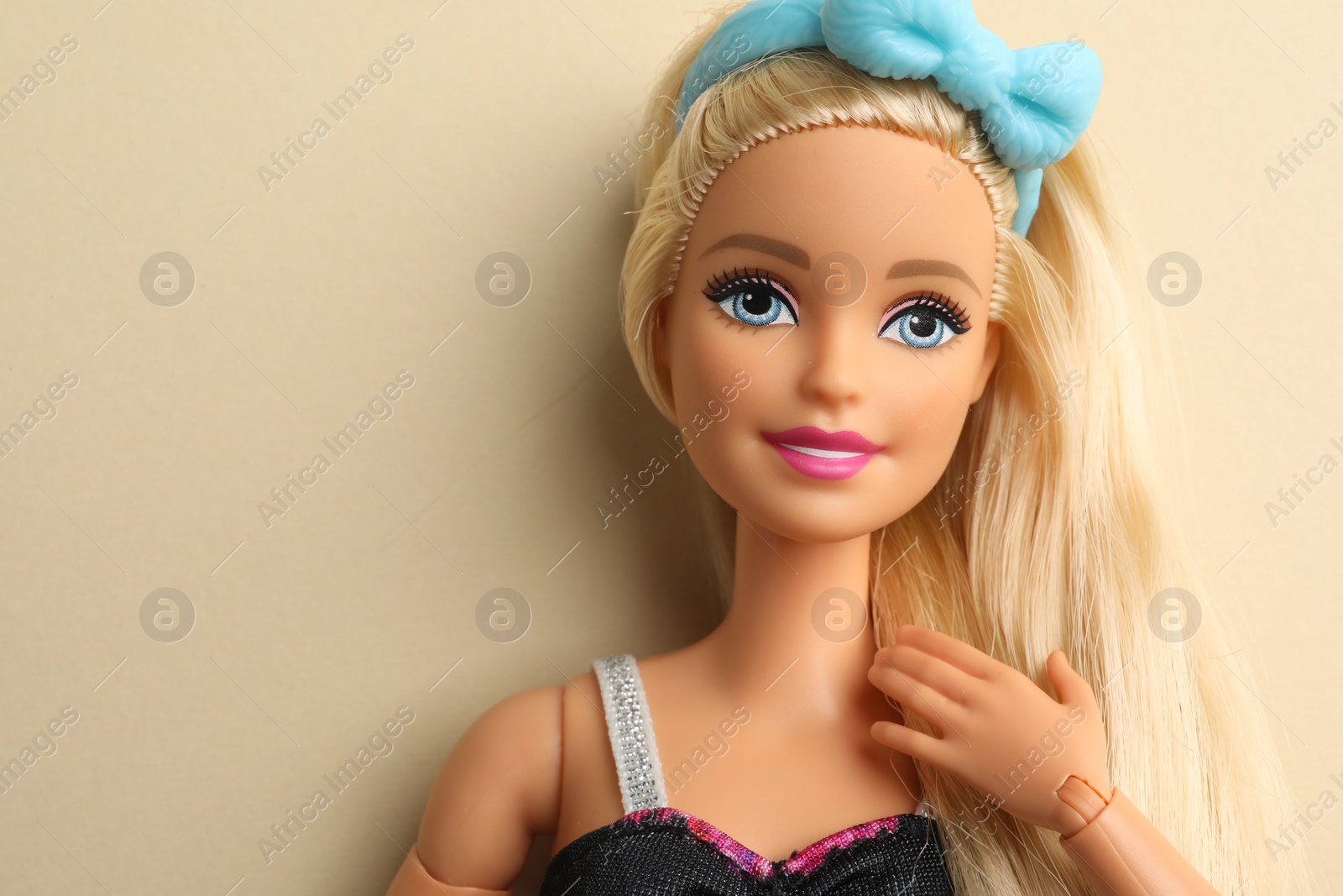 Photo of Mykolaiv, Ukraine - September 4, 2023: Beautiful Barbie doll on beige background, space for text