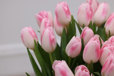 Photo of Beautiful bouquet of fresh pink tulips on blurred background, closeup