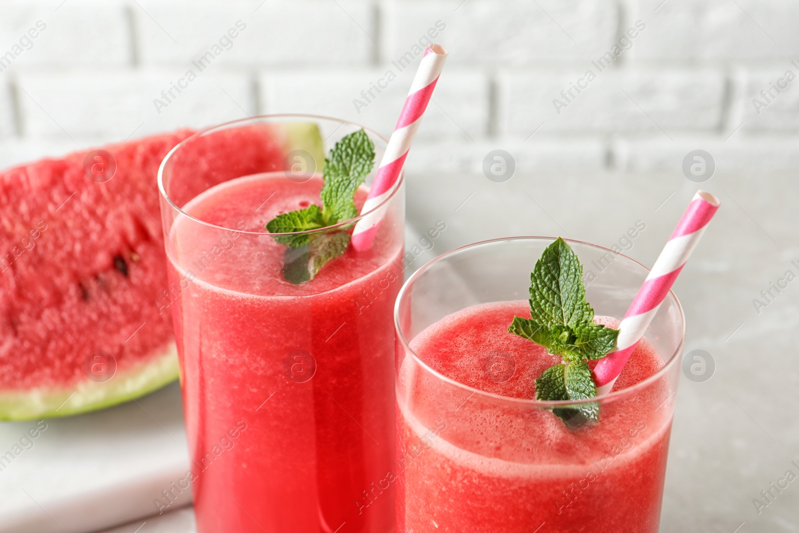 Photo of Tasty summer watermelon drink with mint in glasses, closeup