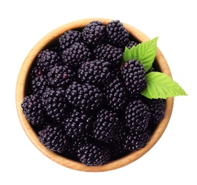 Wooden bowl of tasty ripe blackberries with leaves on white background, top view