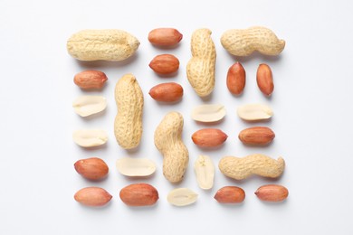 Photo of Fresh peanuts on white background, flat lay