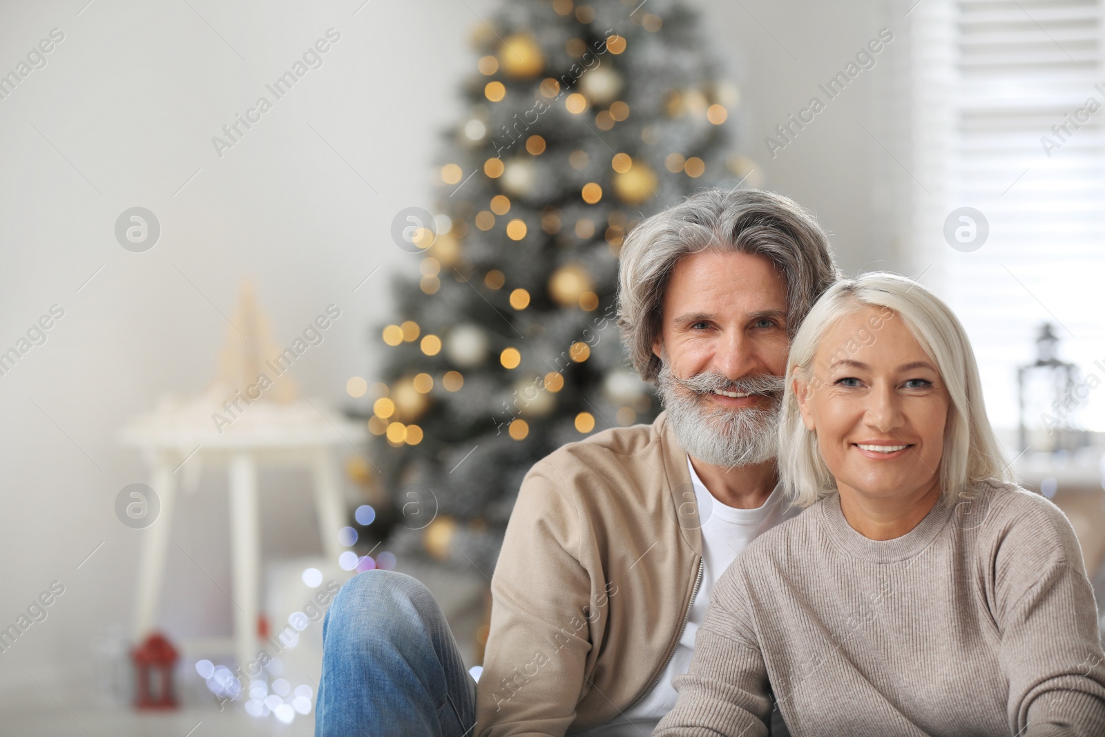 Photo of Happy mature couple celebrating Christmas at home