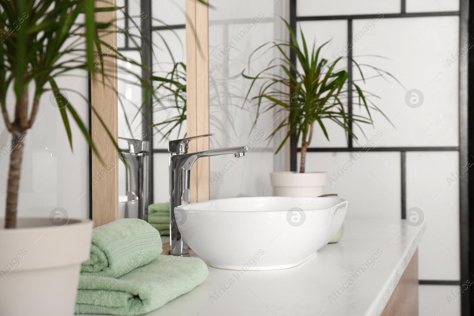 Photo of Mirror and vessel sink in stylish bathroom