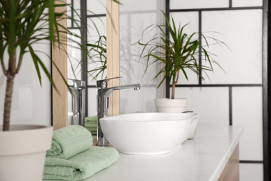 Mirror and vessel sink in stylish bathroom