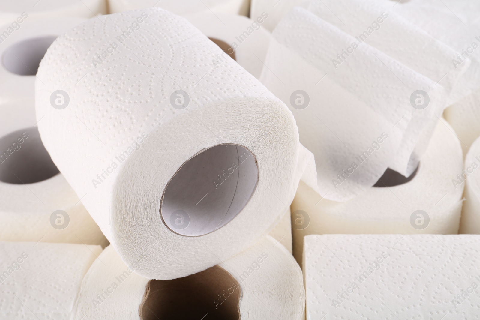 Photo of Many soft toilet paper rolls as background, closeup