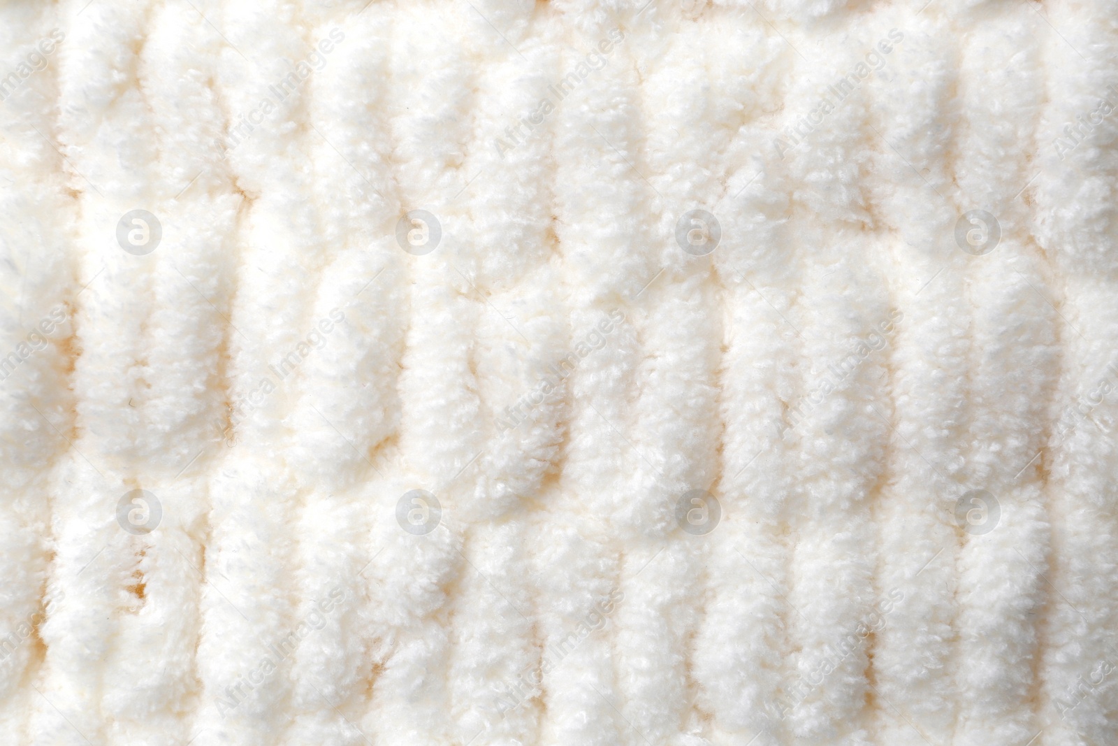 Photo of Soft white knitted fabric as background, top view