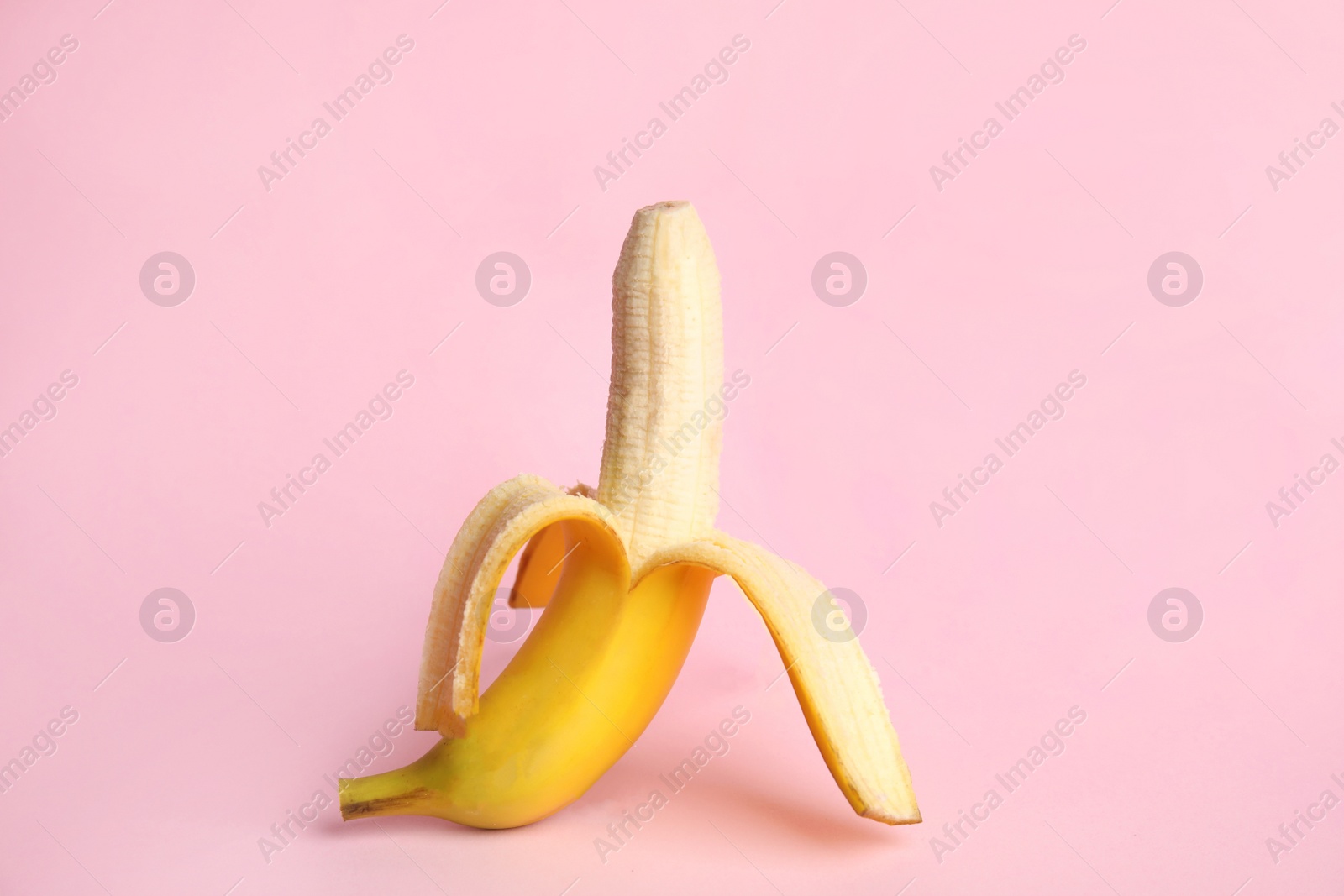 Photo of Fresh banana on pink background. Sex concept