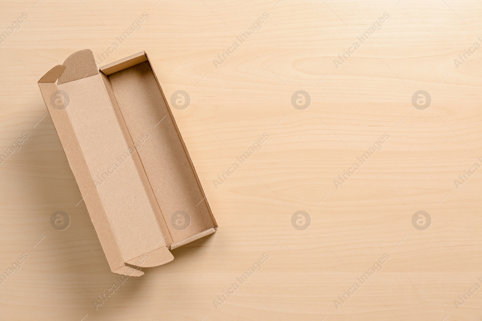 Photo of Cardboard box on wooden background