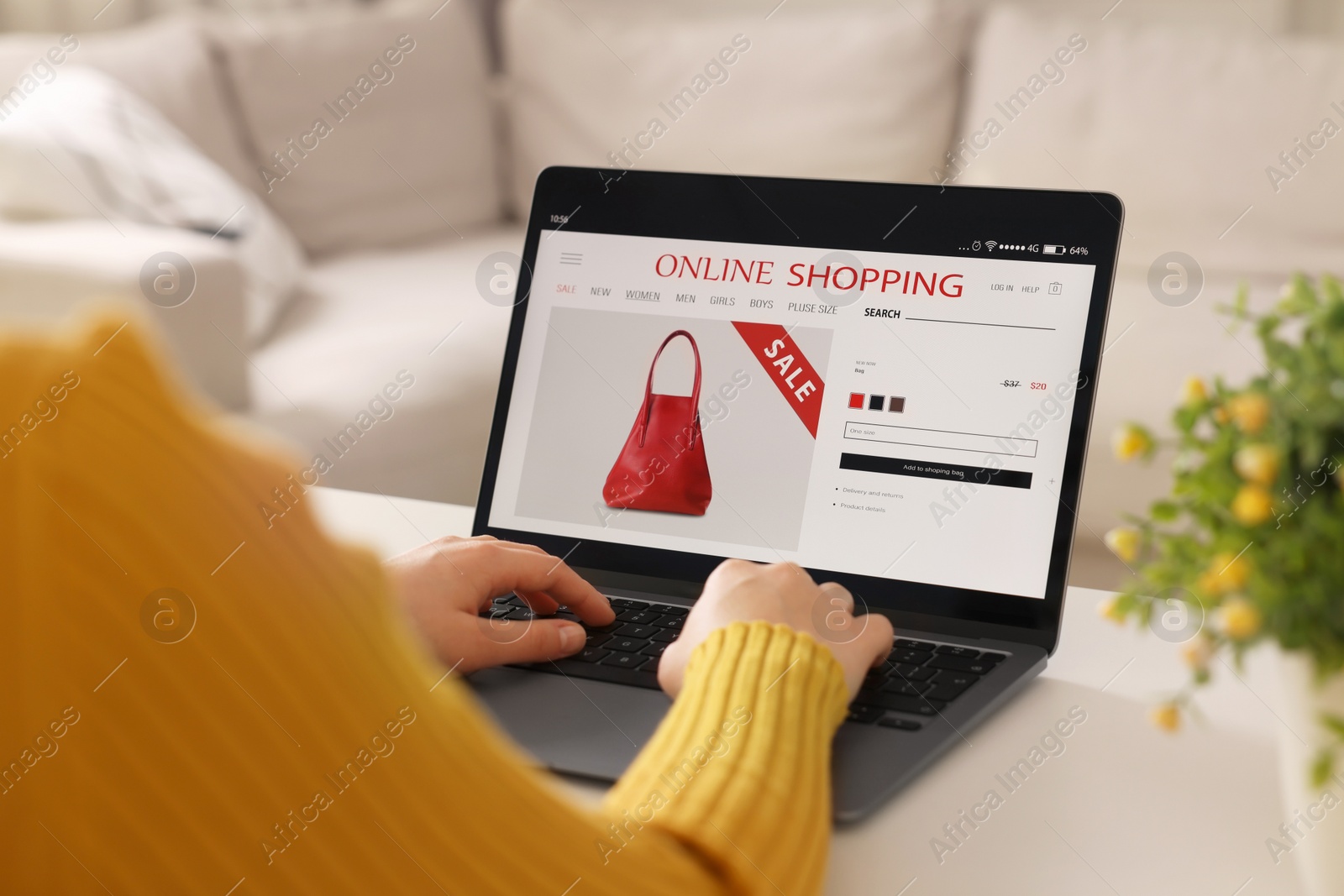 Photo of Woman shopping online during sale on laptop at home, closeup