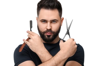 Photo of Handsome young man with mustache holding blade and scissors on white background