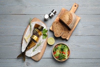 Flat lay composition with smoked fish on light grey wooden table