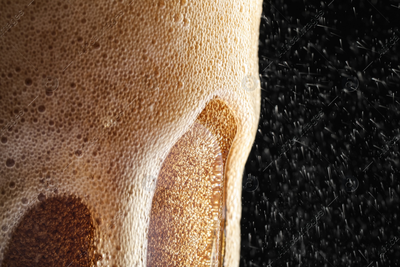 Photo of Glass of refreshing soda drink on black background, closeup