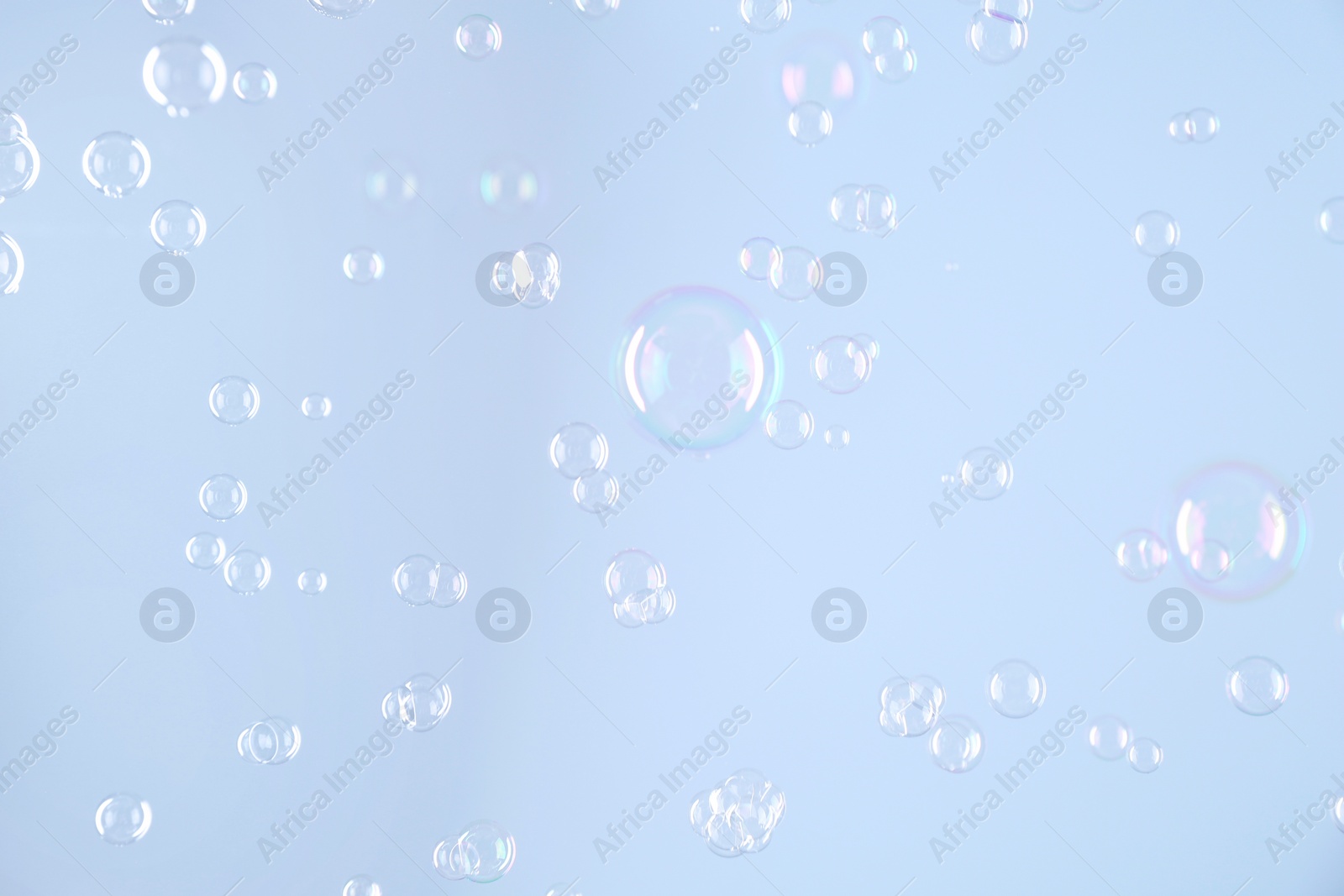 Photo of Beautiful transparent soap bubbles on light grey background