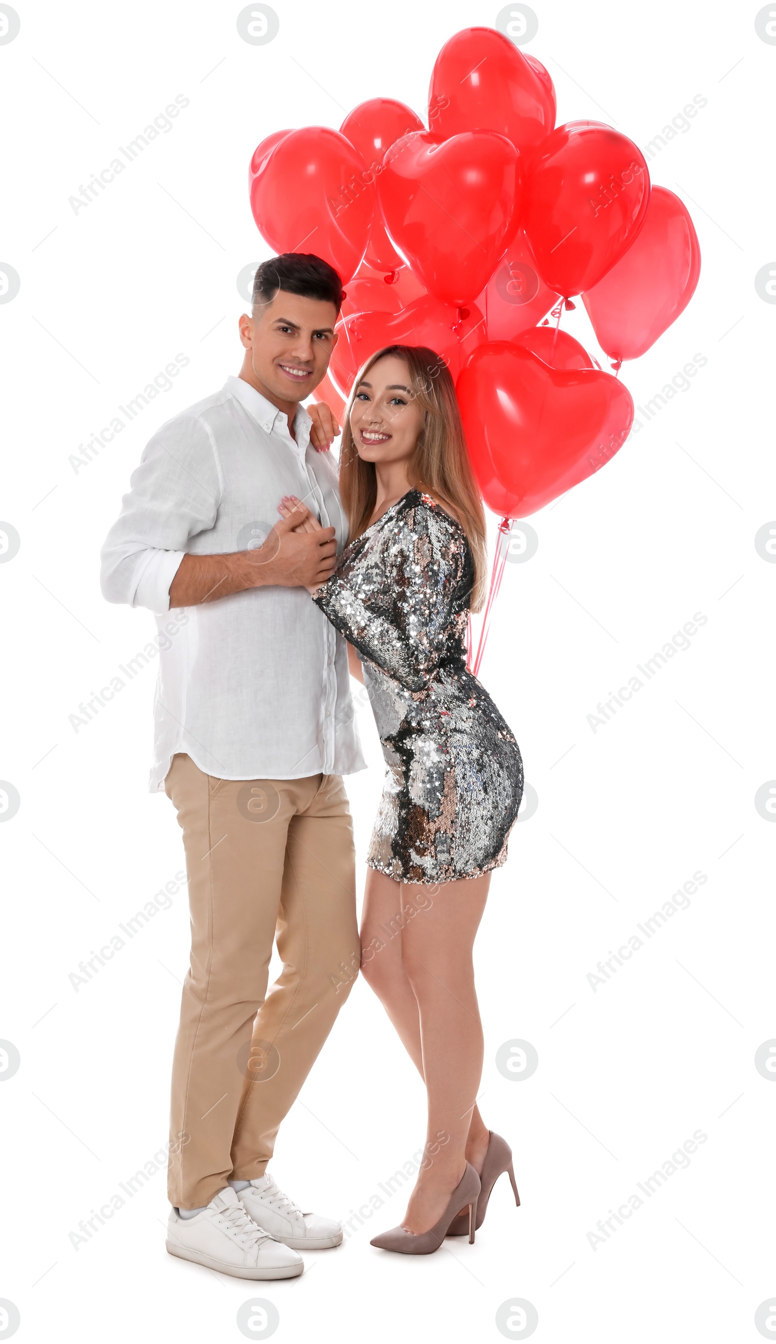 Photo of Lovely couple with heart shaped balloons on white background. Valentine's day celebration