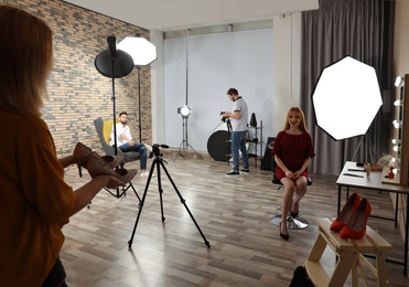 Photo studio with professional equipment and team of workers